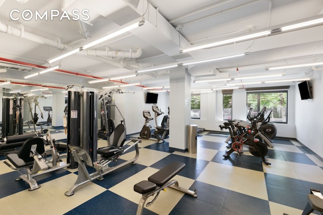 exercise room with tile patterned floors