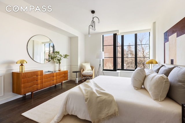 bedroom with dark wood finished floors