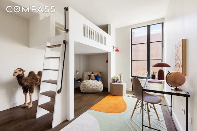 bedroom with wood finished floors and baseboards