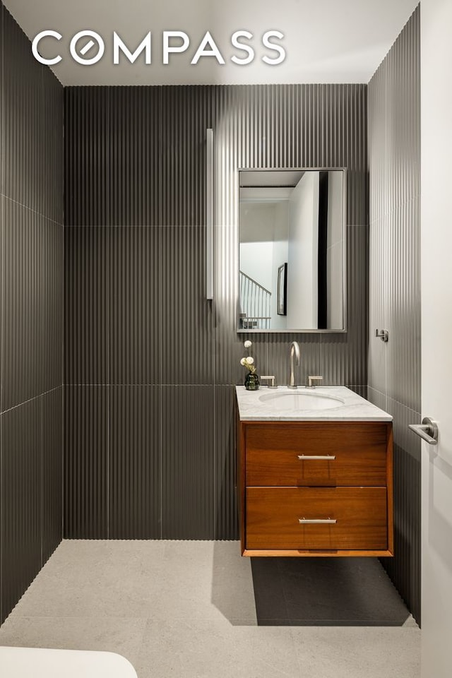 bathroom featuring vanity, tile patterned floors, and toilet