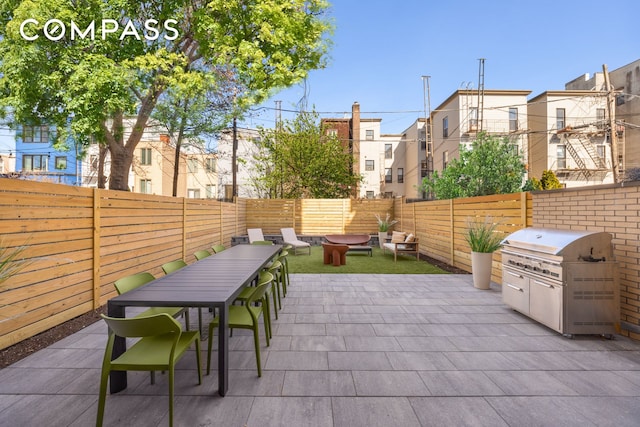 view of patio with outdoor dining area and a fenced backyard