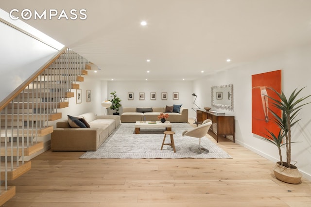 living area featuring recessed lighting, stairs, baseboards, and wood finished floors