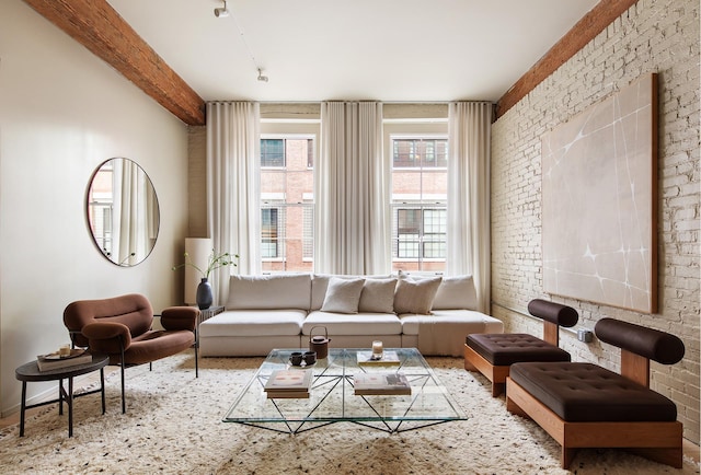 living area with beamed ceiling and brick wall