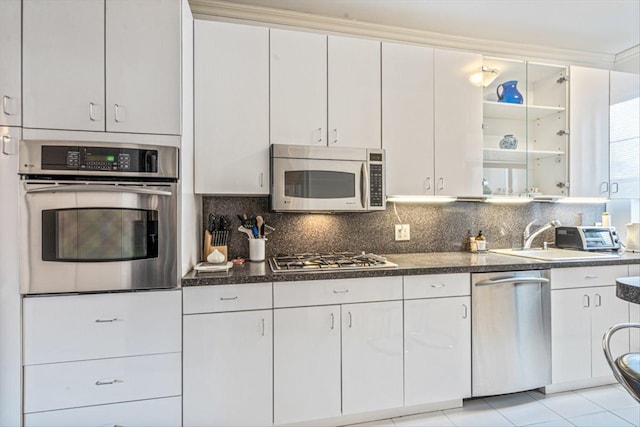 kitchen with white cabinetry, tasteful backsplash, appliances with stainless steel finishes, and a sink