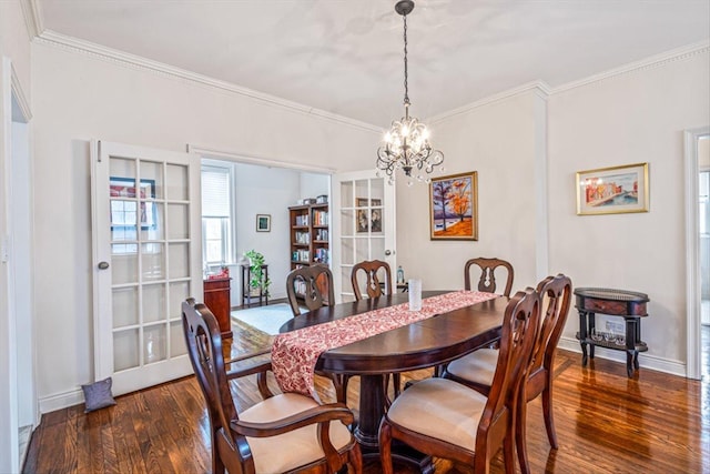 dining space featuring dark wood-type flooring, french doors, crown molding, baseboards, and a chandelier