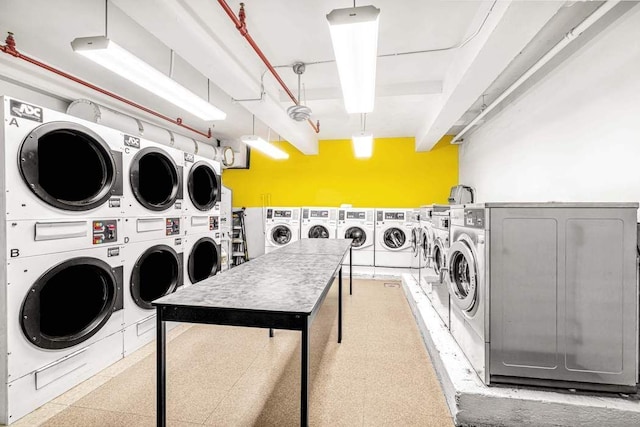 community laundry room featuring separate washer and dryer and stacked washer / dryer