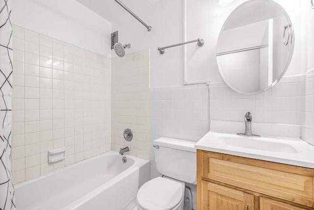 full bathroom featuring shower / bath combination with curtain, vanity, toilet, and tile walls