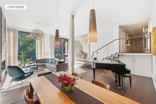 dining room with stairway, wood finished floors, visible vents, and a wealth of natural light