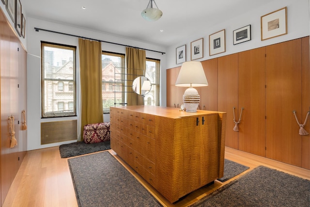 office space featuring light wood finished floors and radiator heating unit