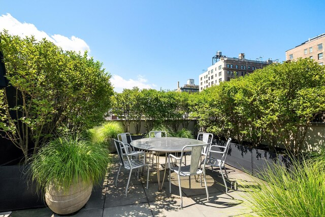 view of patio with outdoor dining space and fence