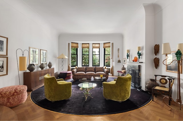 living room with a fireplace and a high ceiling