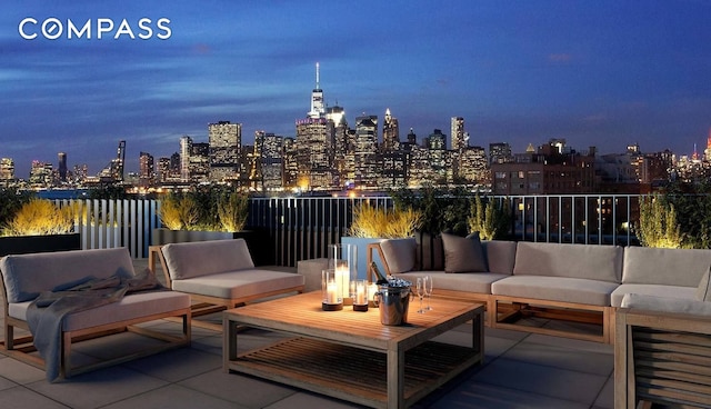 patio at twilight featuring a view of city lights and outdoor lounge area