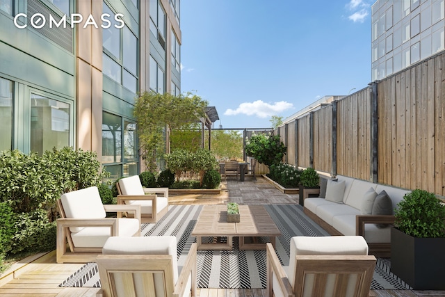 view of patio featuring fence and an outdoor hangout area