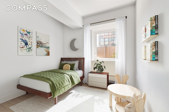 bedroom featuring light wood-type flooring and baseboards