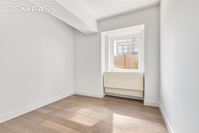 unfurnished room featuring wood finished floors and baseboards