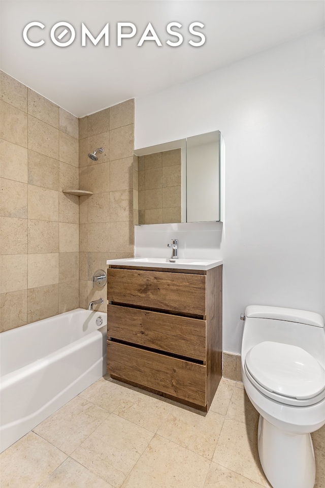 full bathroom featuring tile patterned flooring, toilet, vanity, and bathing tub / shower combination