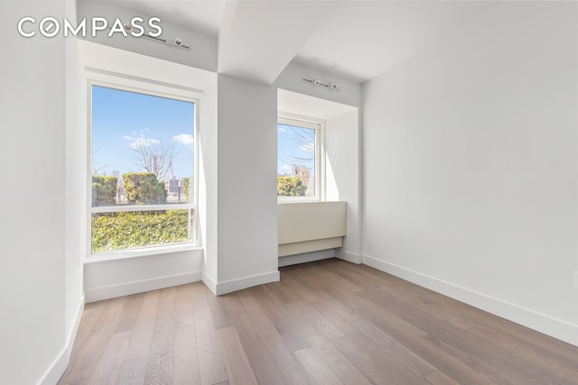 empty room featuring baseboards and wood finished floors