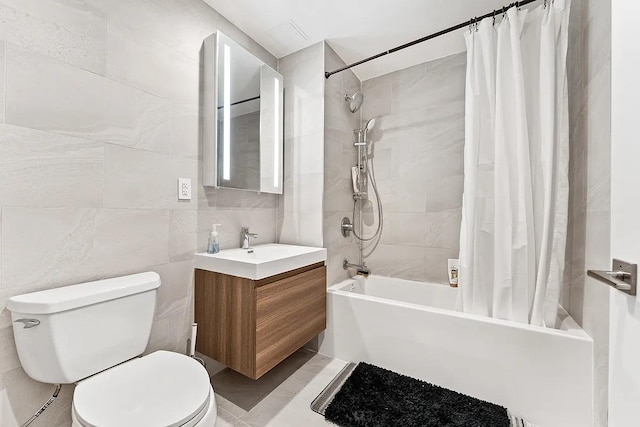 full bath with vanity, toilet, tile walls, and shower / tub combo