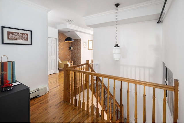 corridor featuring wood finished floors, ornamental molding, an upstairs landing, and a baseboard radiator