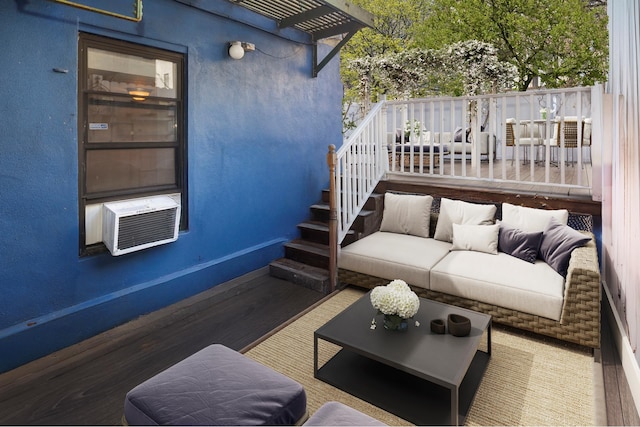 exterior space with stairway, cooling unit, wood finished floors, and a textured wall