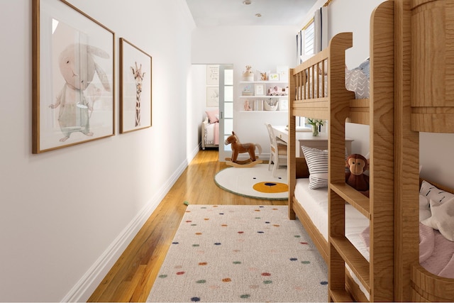 hallway with baseboards and hardwood / wood-style floors