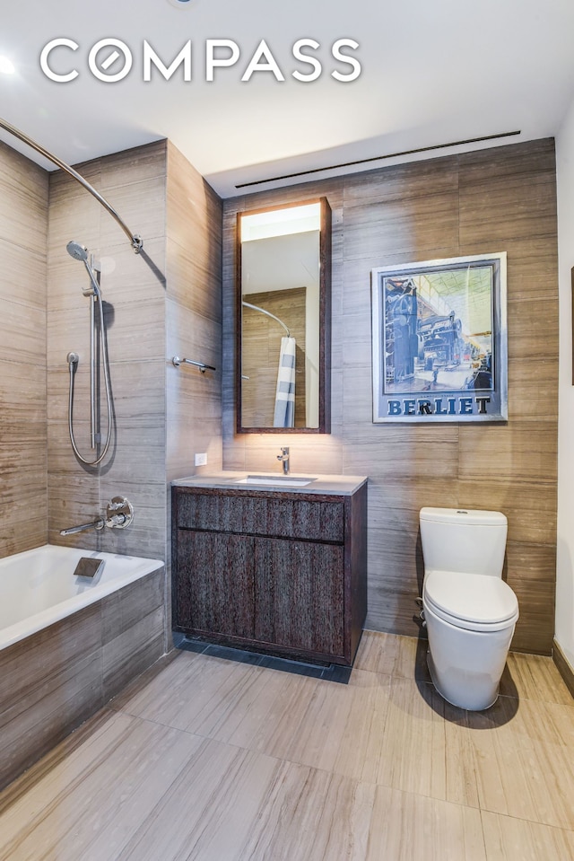 full bathroom with vanity, toilet, and tiled shower / bath combo