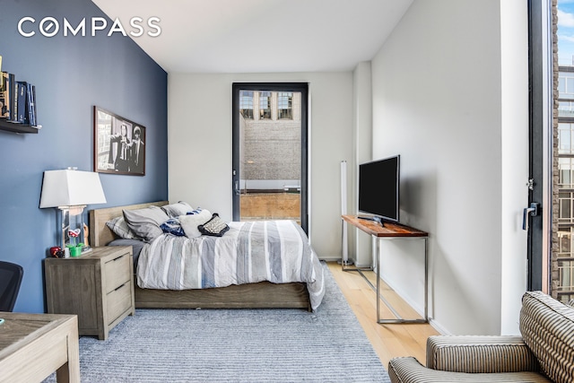 bedroom featuring baseboards and wood finished floors