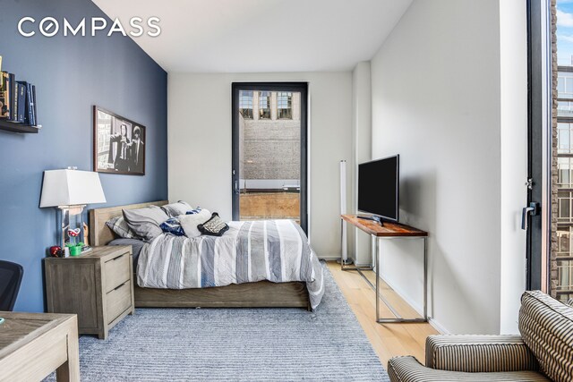 505 W 19th St Unit 7W, New York City, NY 10011 - bedroom with baseboards and wood finished floors