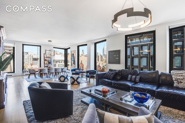 505 W 19th St Unit 7W, New York City, NY 10011 - living area featuring a view of city and wood finished floors