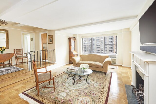 235 E 73rd St Unit 8D, New York City, NY 10021 - living room with baseboards and a fireplace with flush hearth