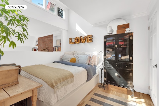 bedroom featuring crown molding and wood finished floors