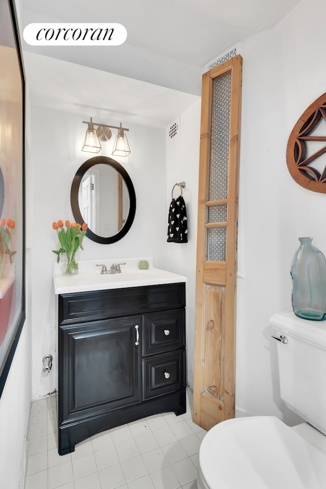 bathroom with toilet and vanity