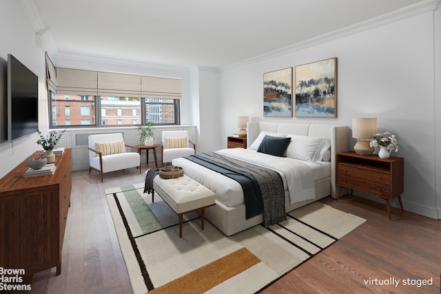 bedroom featuring wood-type flooring and ornamental molding