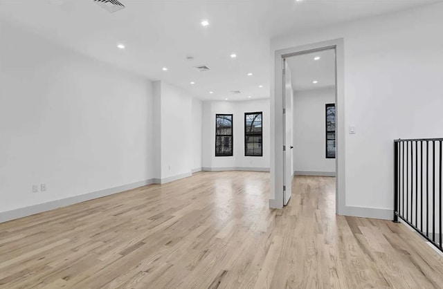 spare room with baseboards, recessed lighting, visible vents, and light wood-type flooring