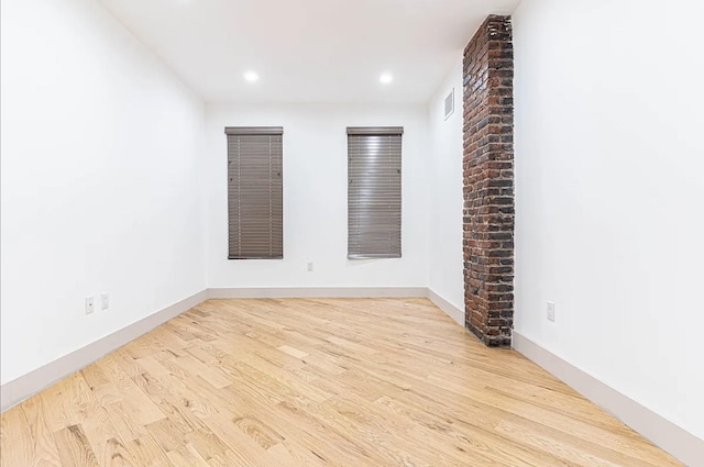 empty room featuring recessed lighting, visible vents, baseboards, and wood finished floors