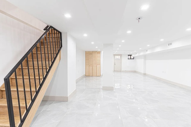 282 E 38th St, New York City, NY 11203 - finished basement with recessed lighting, stairs, baseboards, and light marble finish flooring