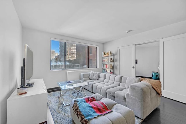 living area with baseboards and dark wood-type flooring