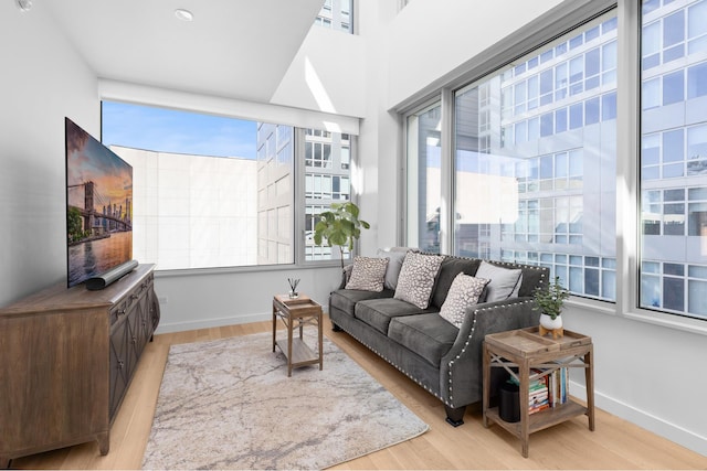 living area with baseboards and light wood-type flooring