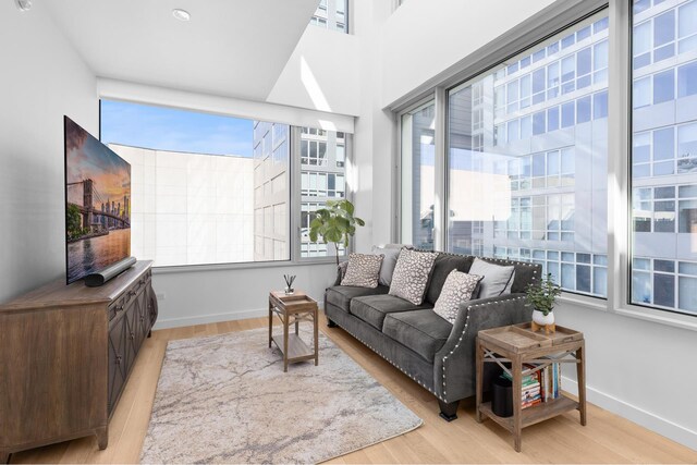 611 W 56th St Unit 7E, New York City, NY 10019 - living area with baseboards and light wood-type flooring