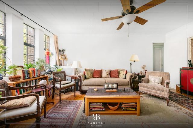 living area with ceiling fan and wood finished floors