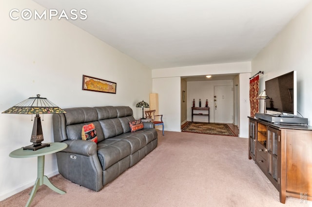 living room with baseboards and light colored carpet