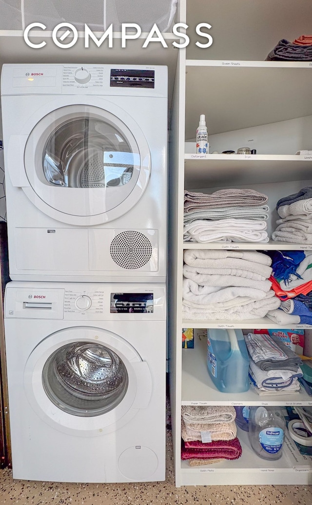 laundry room with stacked washer and dryer and laundry area