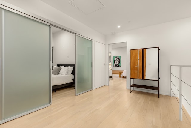 bedroom with a closet, recessed lighting, and light wood-style floors