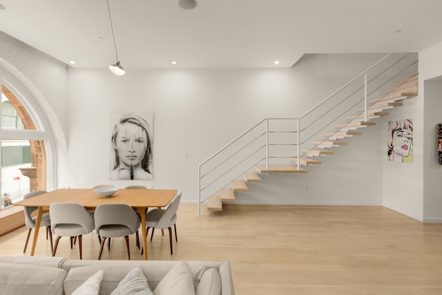 dining space featuring stairway, recessed lighting, baseboards, and light wood-style floors