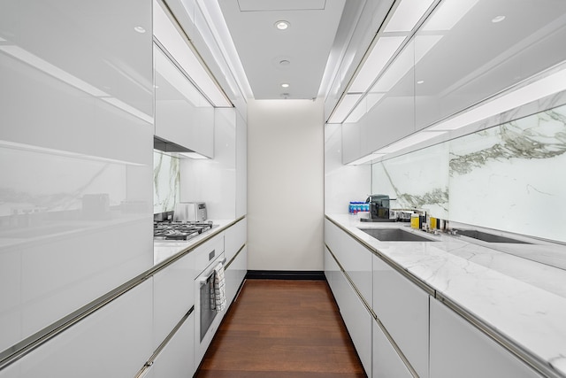 53 W 53rd St Unit 20C, New York City, NY 10019 - kitchen featuring white cabinetry, a sink, modern cabinets, and recessed lighting