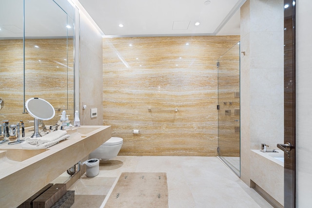 bathroom with tile patterned floors, toilet, a washtub, a tile shower, and recessed lighting