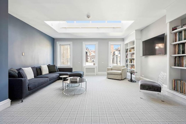 123 E 69th St, New York City, NY 10021 - living area featuring a skylight, built in features, carpet, baseboards, and a raised ceiling