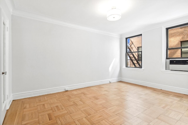unfurnished room with crown molding, baseboards, and cooling unit