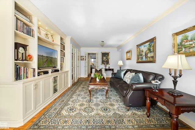 living area featuring french doors, light wood-type flooring, and crown molding