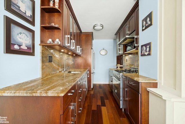 kitchen featuring light stone countertops, open shelves, a sink, stainless steel appliances, and dark wood-type flooring